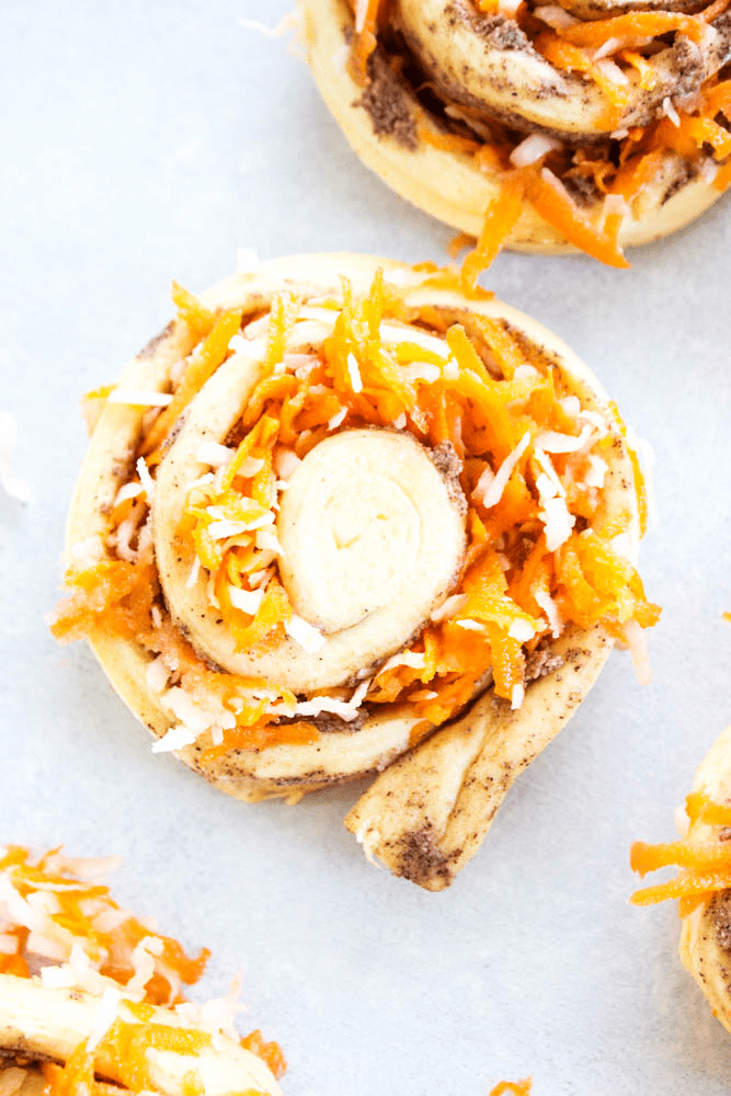 photo of cinnamon roll dough rolled with shredded carrot filling