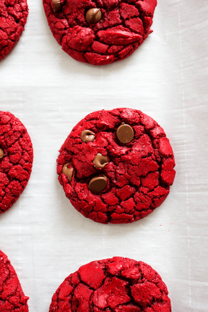 top down view of red velvet cookies on parchment paper