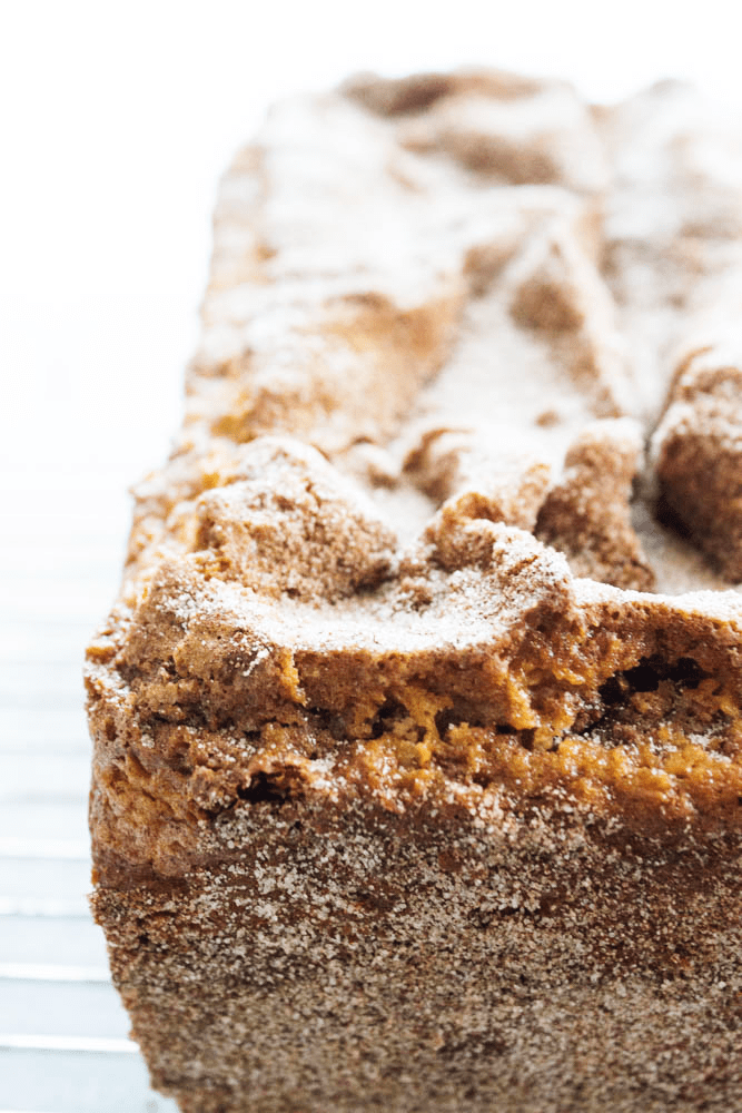 CINNAMON SUGAR BREAD is like eating a cinnamon & sugar cake donut but better. Easy & delicious this bread is ready to devour in an hour. close up photo of the corner of a loaf of cinnamon sugar bread