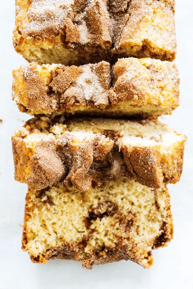 CINNAMON SUGAR BREAD is like eating a cinnamon & sugar cake donut but better. Easy & delicious this bread is ready to devour in an hour. photo of sliced cinnamon sugar bread loaf