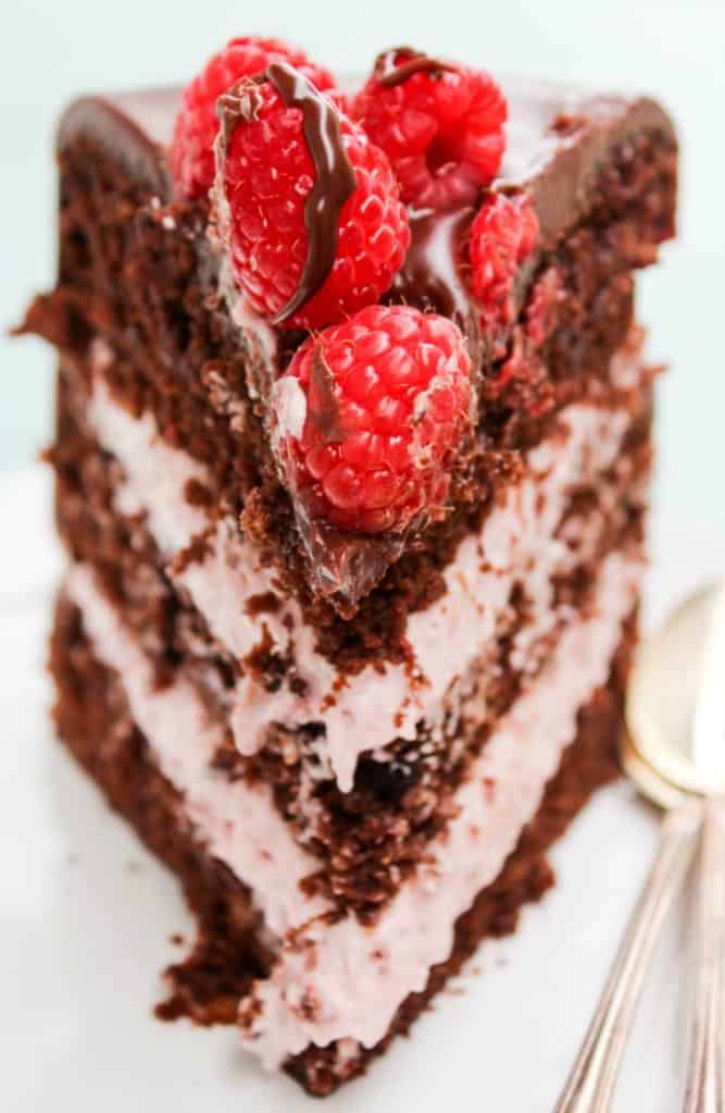 chocolate raspberry layer cake slice with fresh raspberries on top