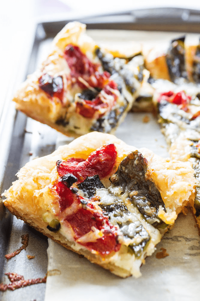 close up Roasted Chile Cheese Tart slices on a baking tray lined with parchment