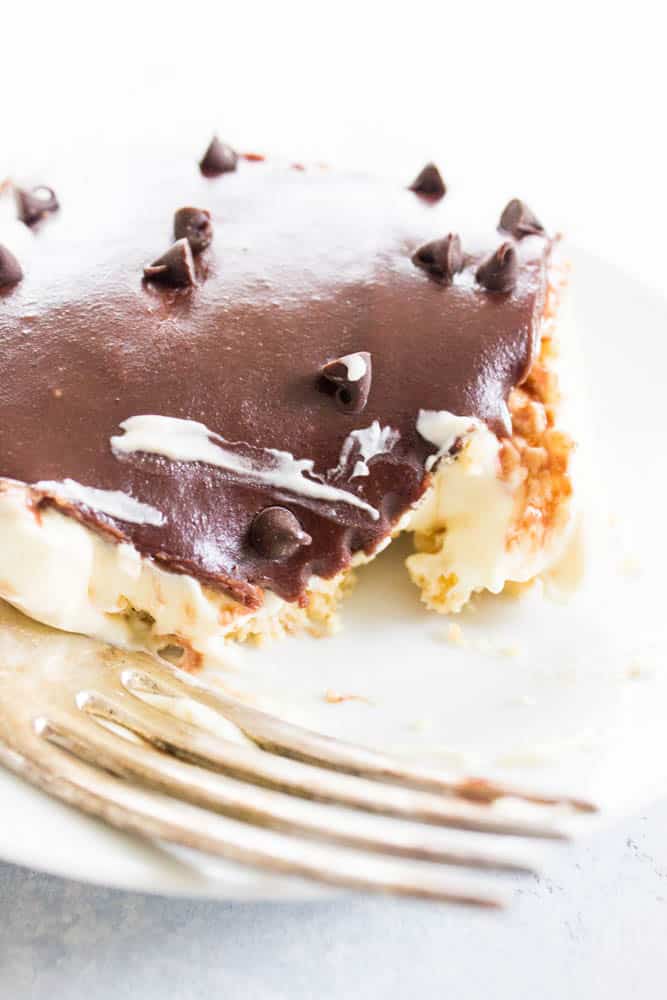 No-Bake Boston Cream Pie Cheesecake slice up close on a plate with bite taken