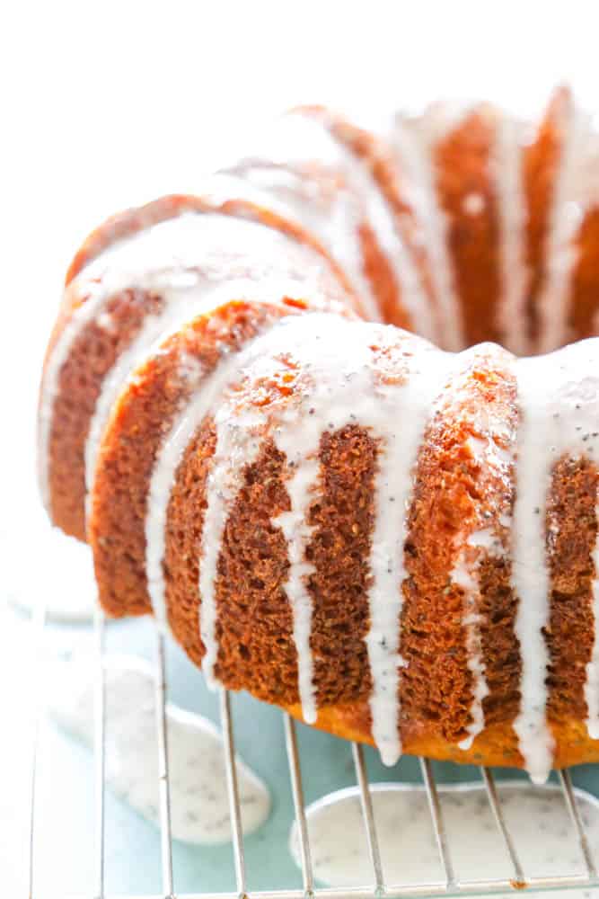 iced Poppy Seed bundt cake on a wire cooling rack 