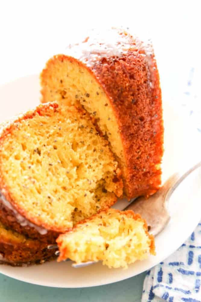 bite of Poppy Seed Cake on plate with 2 slices