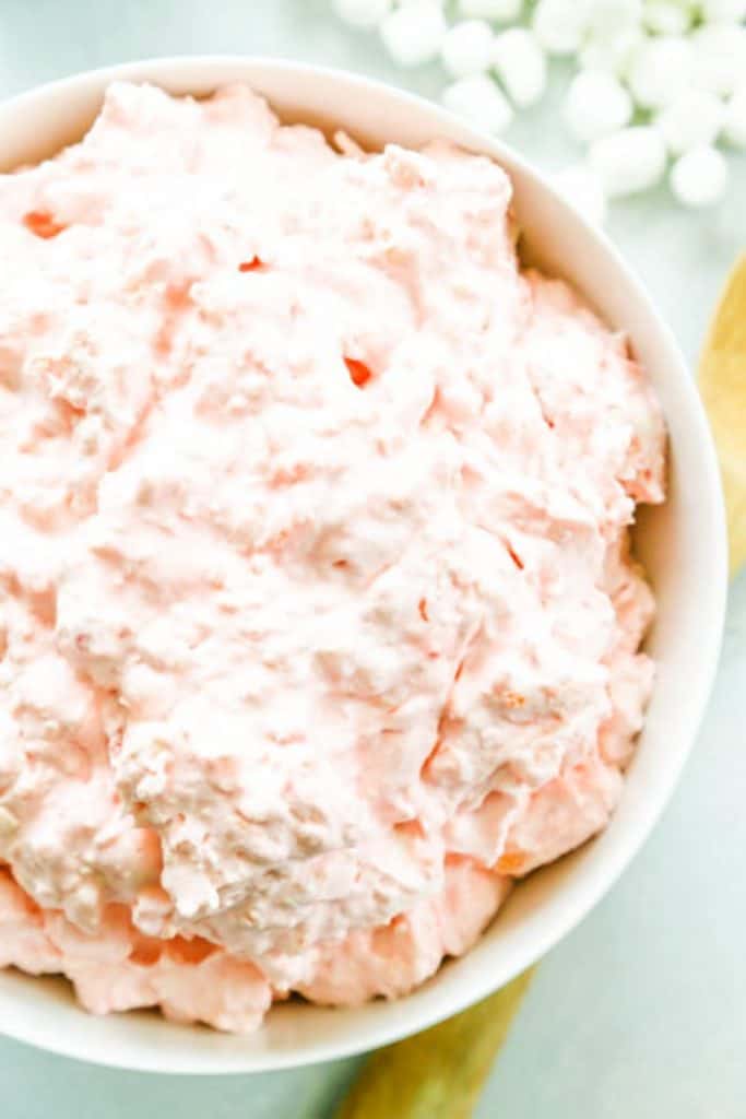 Pink Pineapple Fluff in a white serving bowl