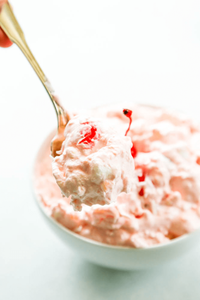 spoonful of Pink Pineapple Fluff up close with full bowl in background