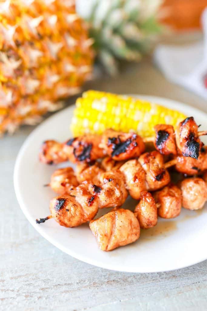 Maple Barbecue Chicken Kabobs on white plate with corn on the cob