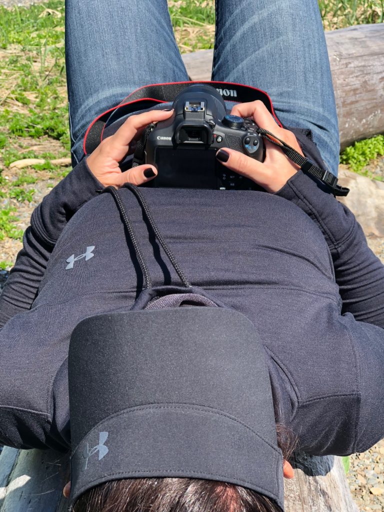 photo of a woman holding a canon camera