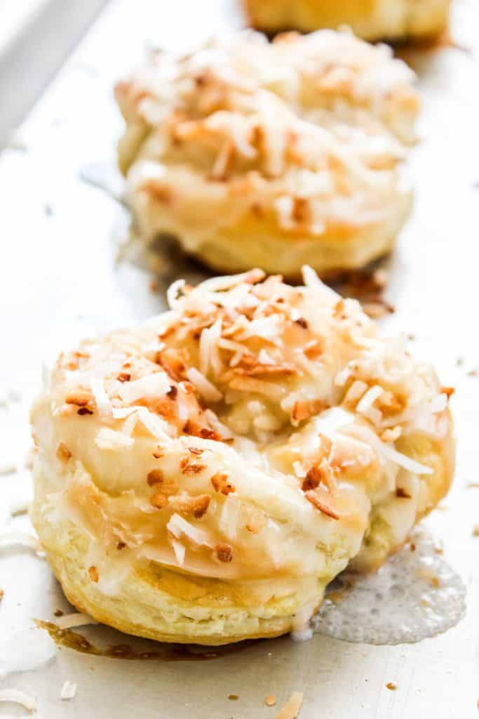 COCONUT KNOTS otherwise known as Coco Knots are deliciously sweet puff pastry that's ready in 30 minutes. You're just a few ingredients from eating the best pastry you've ever had. Coconut Knots baked on a sheet pan
