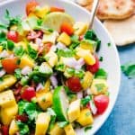 overhead shot mango salsa white bowl with spoon