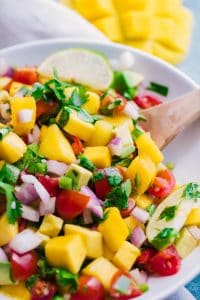 overhead shot mango salsa white bowl with spoon