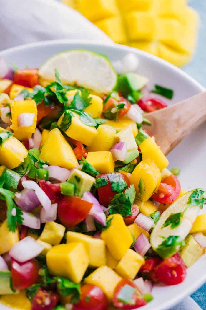 overhead shot mango salsa white bowl with spoon