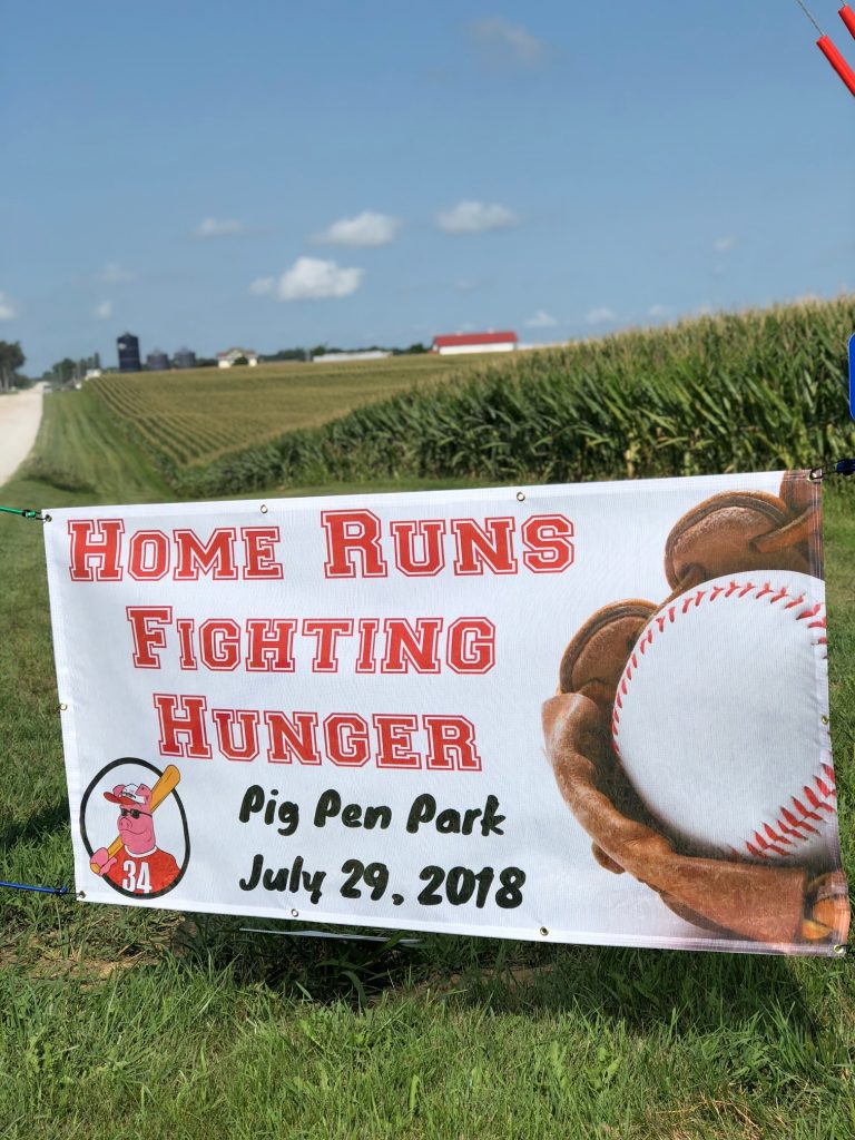 sign that reads "home runs fighting hunger. pig pen park, july 29, 2018"
