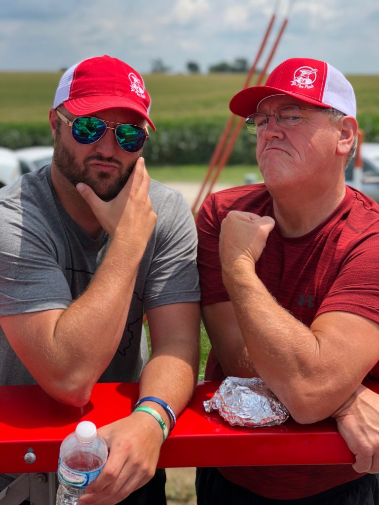 photo of two men with red hats