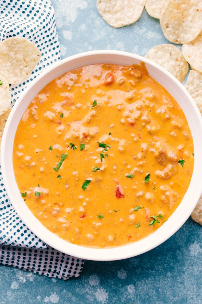 overhead shot of sausage queso dip with chips