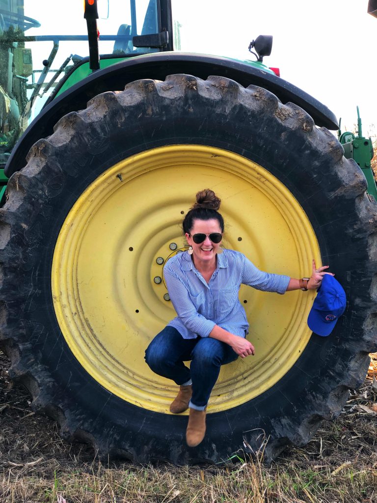 photo of sandra by a large tractor tire
