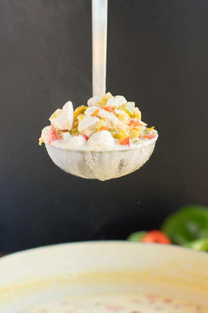 close up of a metal ladle full of mexican corn chowder