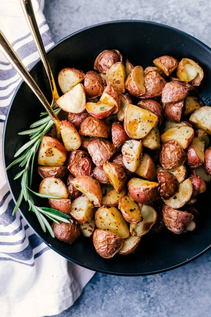 roasted potatoes on a black plate