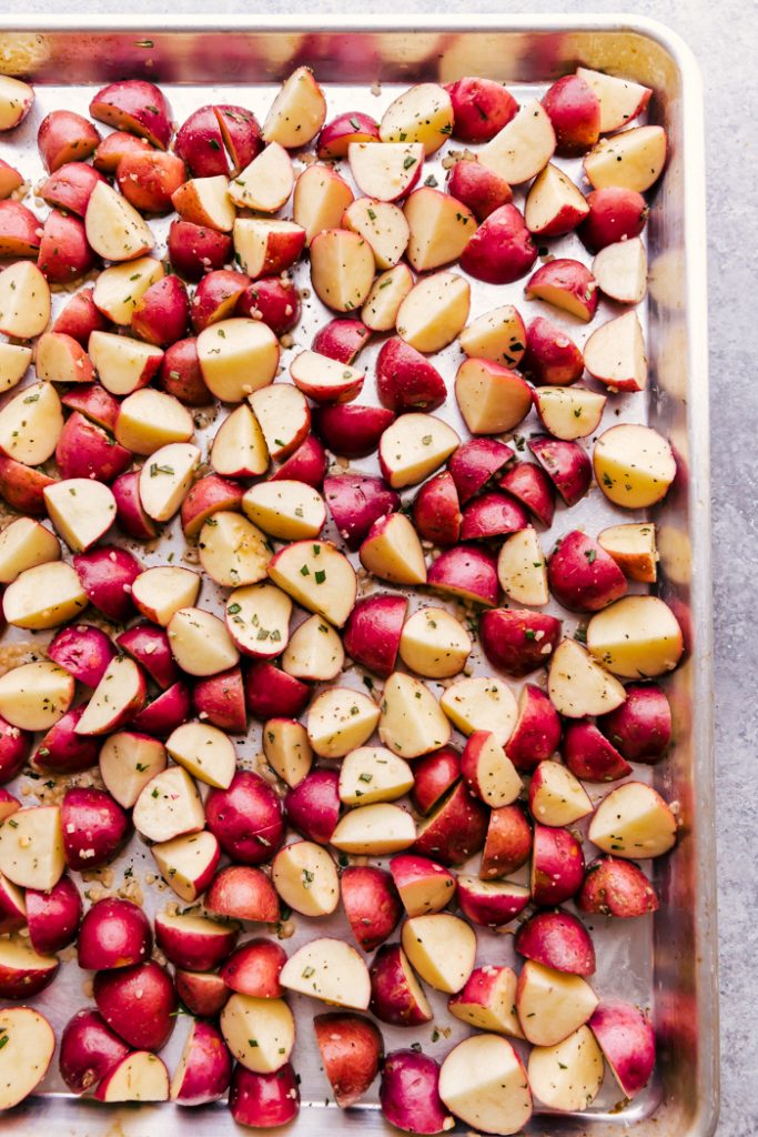 raw cut potatoes on a baking sheet