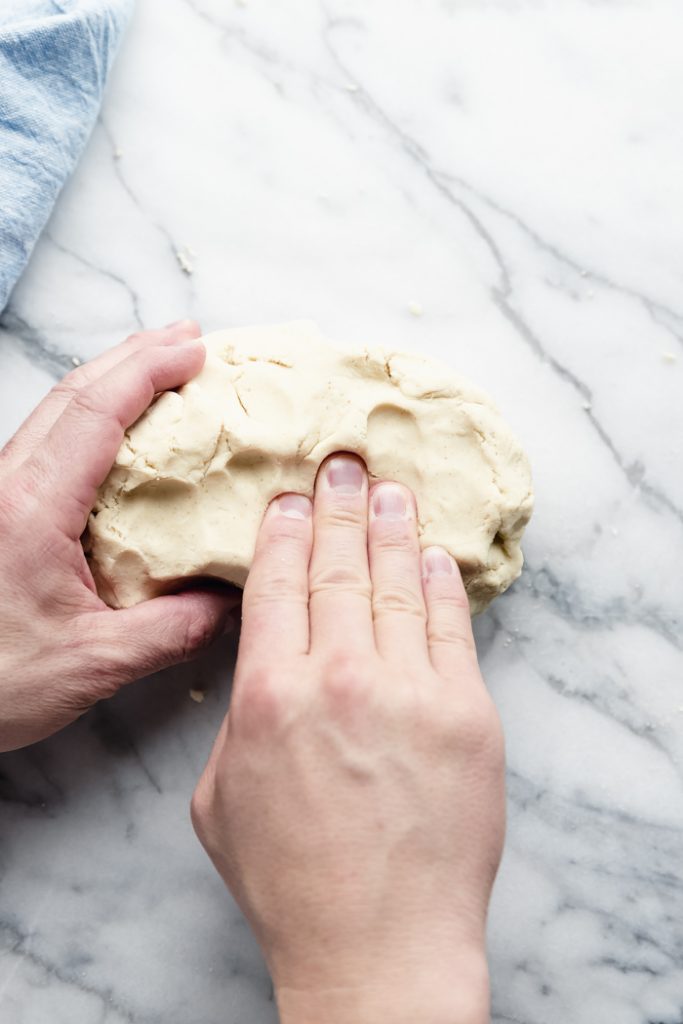 photo of hands kneading the tortilla dough on the countertop