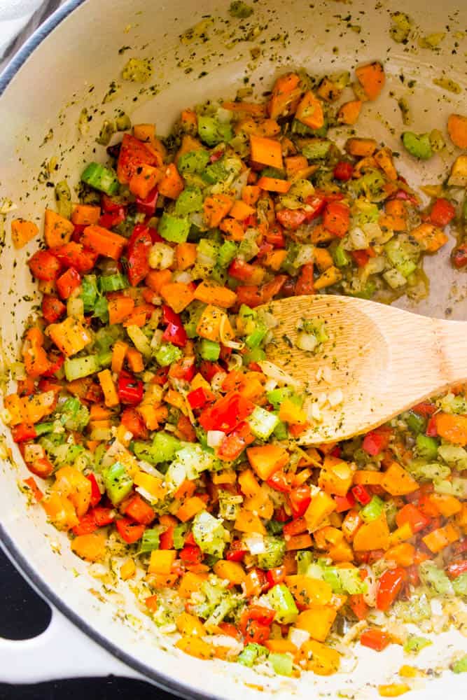 cooked veggies in pot with wooden spatula