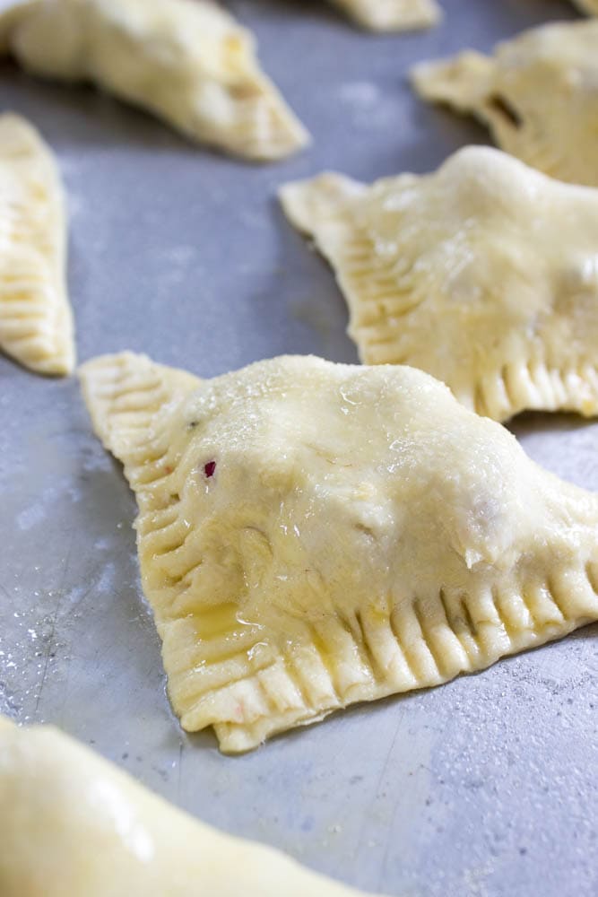 photo of unbaked Chocolate Raspberry Turnovers  on a sheet pan