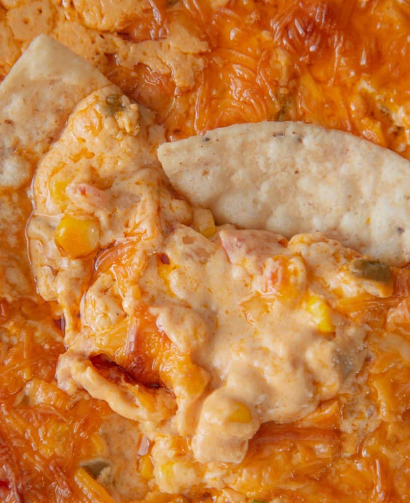 close up of corn queso dip with tortilla chips 