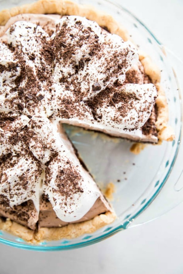 overhead photo of Chocolate Mousse Fudge Pie in pie pan with 1 slice removed