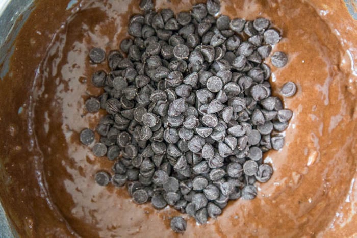 photo of the chocolate chips being added to the batter