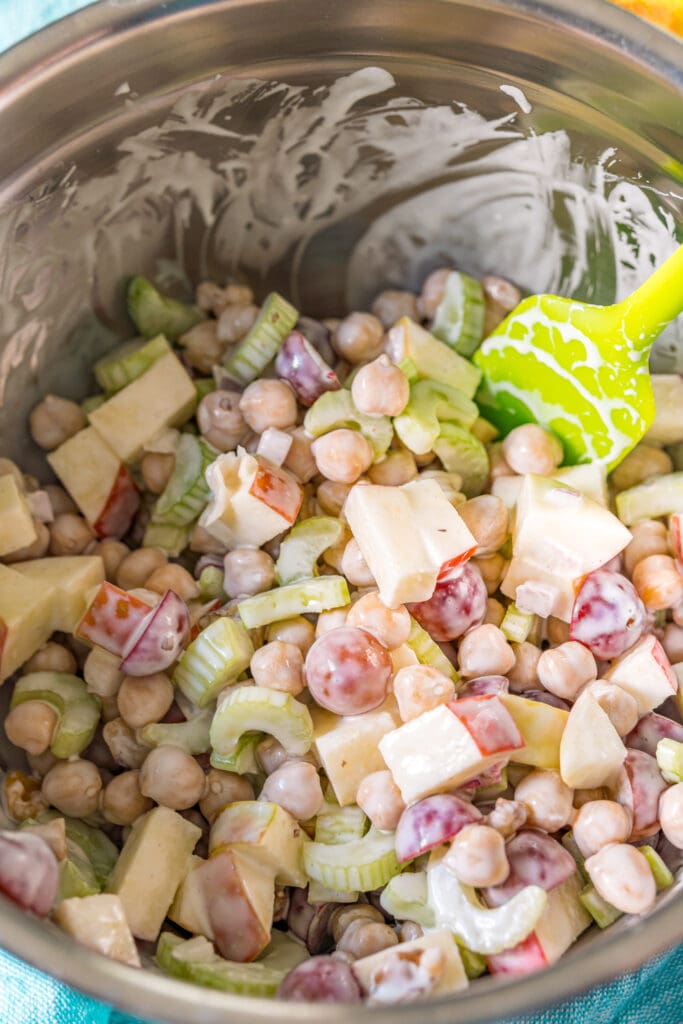 overhead photo of the salad being mixed with the dressing