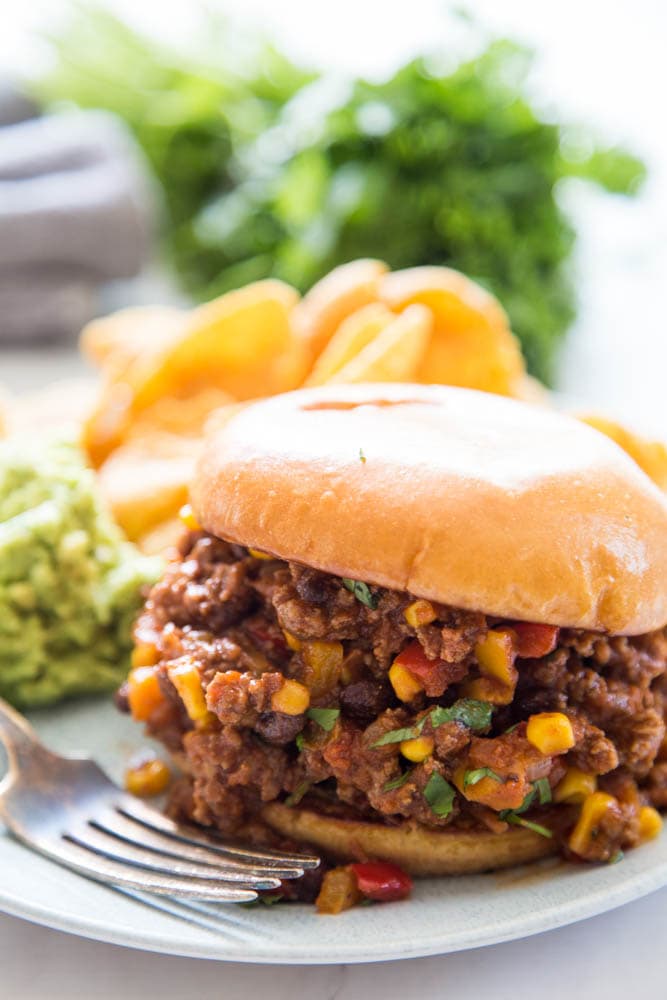 photo of a sloppy joe on a plate with a fork