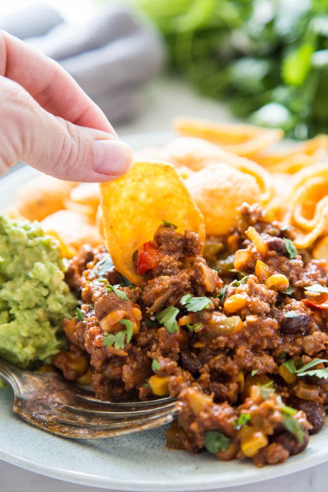 photo of a tortilla chip scooping up the sloppy joe mixture