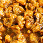close up shot of crispy honey chicken in sauce
