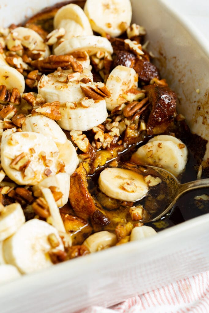 baked french toast with bananas in a baking dish.