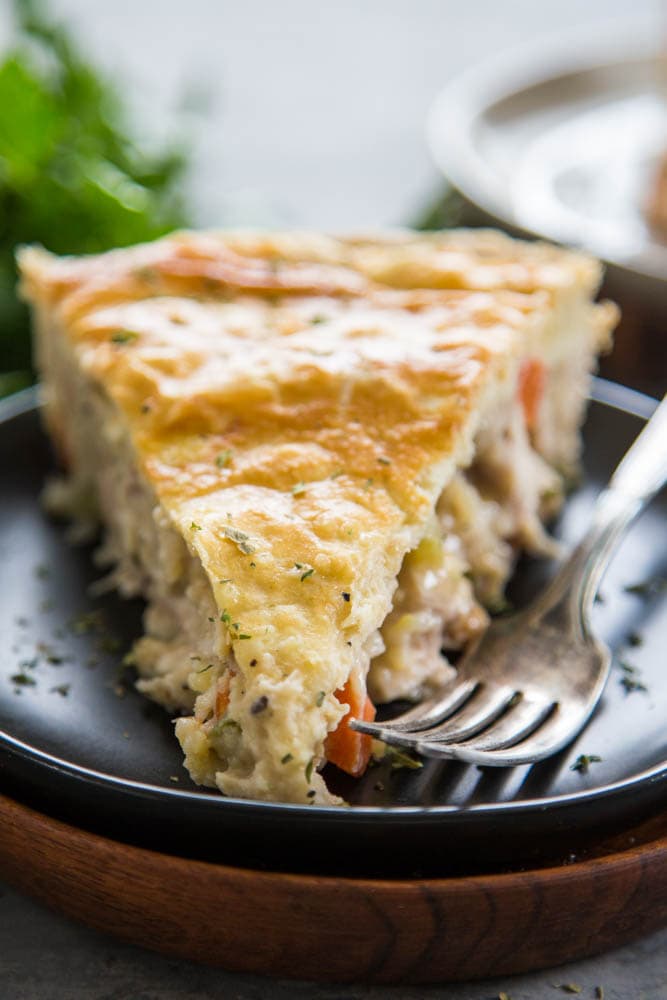 one slice of pot pie on a plate with a fork