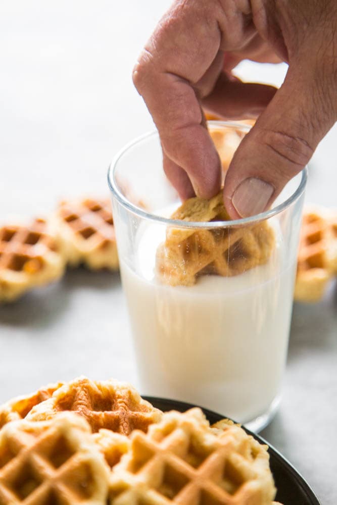 a cookie being dunked in a glass of milk