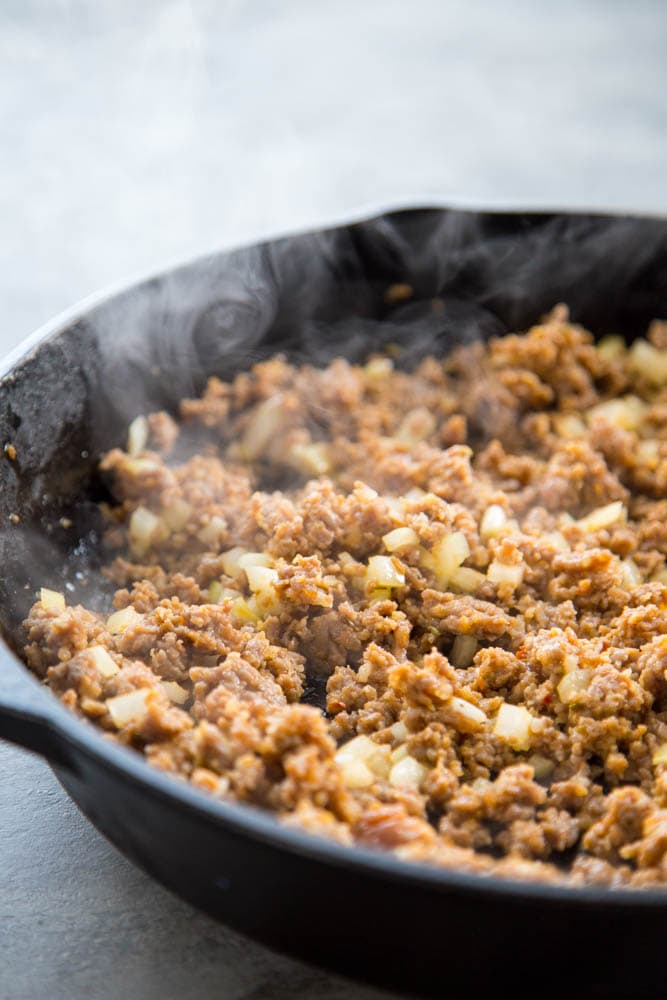 sausage cooking in a skillet
