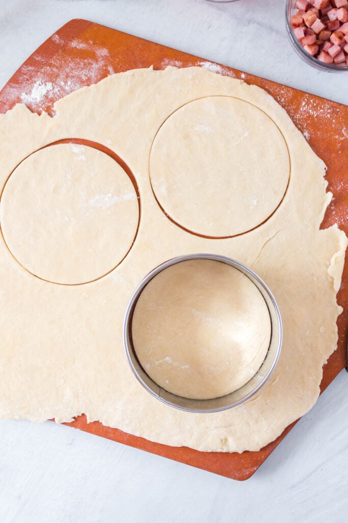circles being cut out of the rolled out dough.