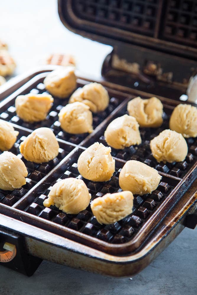 the dough balls placed on the waffle iron