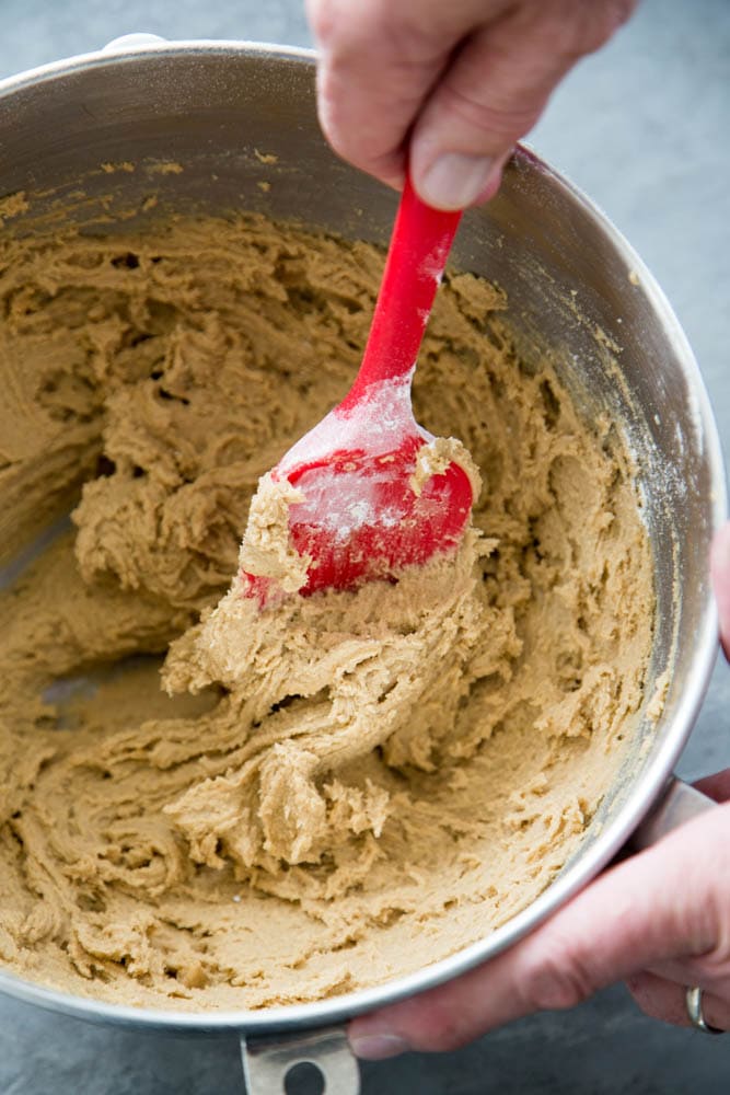 cookie dough being mixed in a bowl.