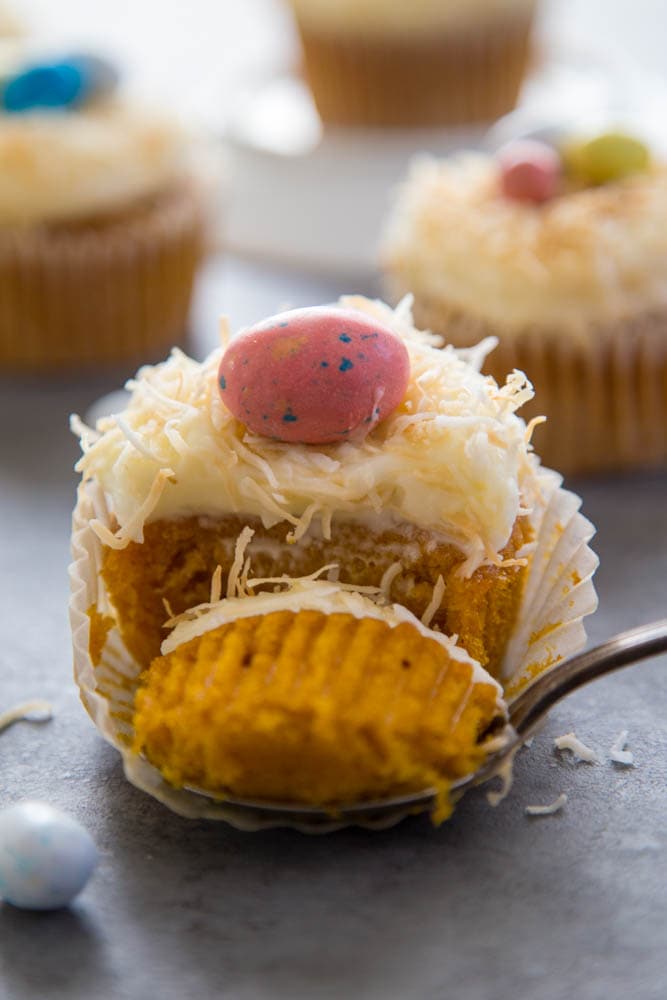 a fork cutting a piece off the cupcake.
