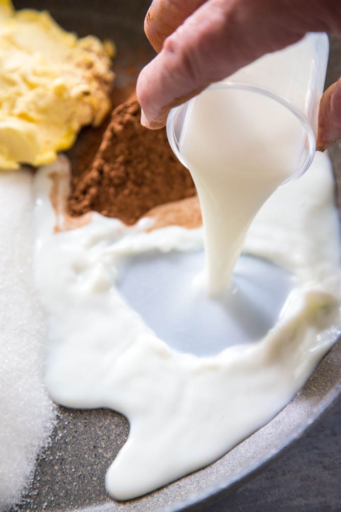 pouring milk into the pan.