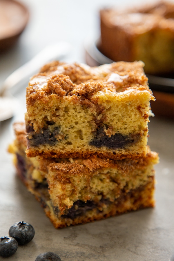 two pieces of blueberry coffee cake stacked