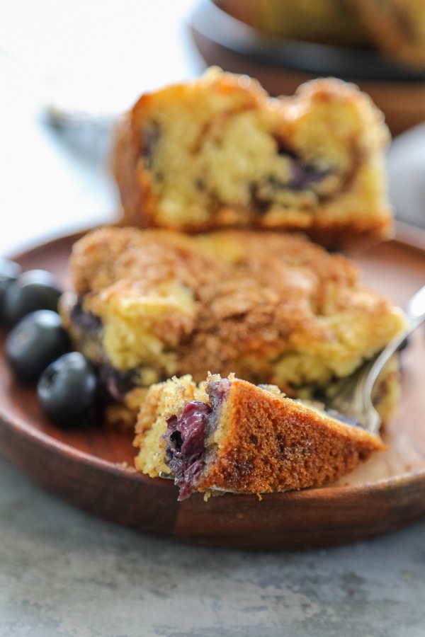 a piece of blueberry coffee cake on a fork.