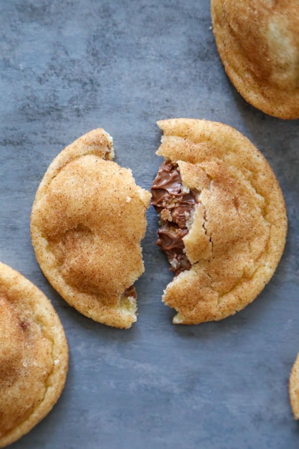 a cookie broken in half with chocolate oozing out.