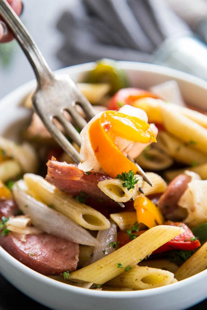 close-up shot of a fork digging into a bowl of pasta.