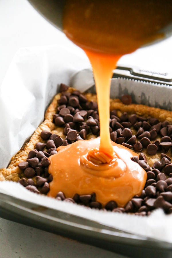 the caramel sauce being poured into the pan.