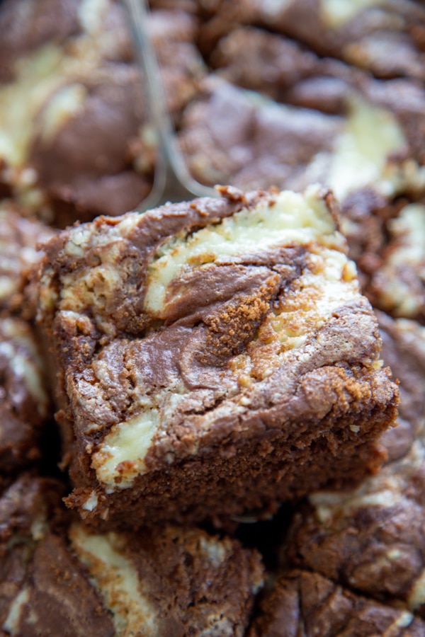 a slice of coffee cake being lifted from the pan.