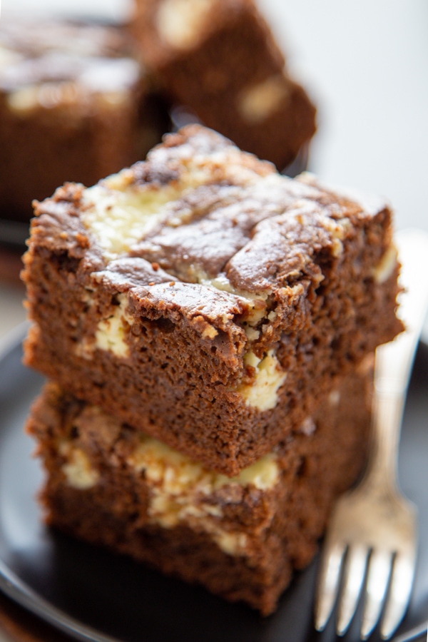 two pieces of coffee cake stacked on a plate.